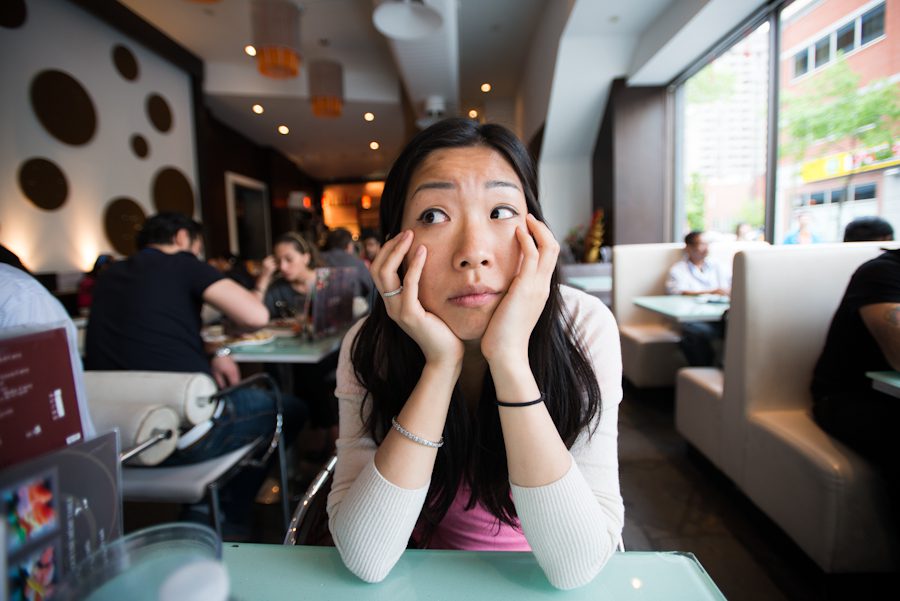 Karis of Ben Lau Photography sits inside a restaurant in Montreal.