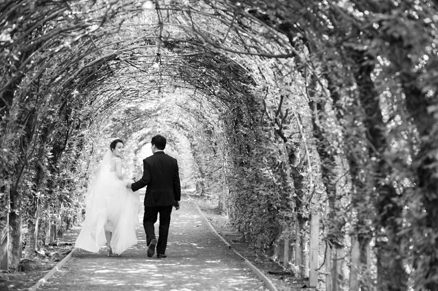 Bride and groom make a getaway after their wedding ceremony at Snug Harbor in Staten Island. Captured by awesome New York Wedding Photographer Ben Lau.