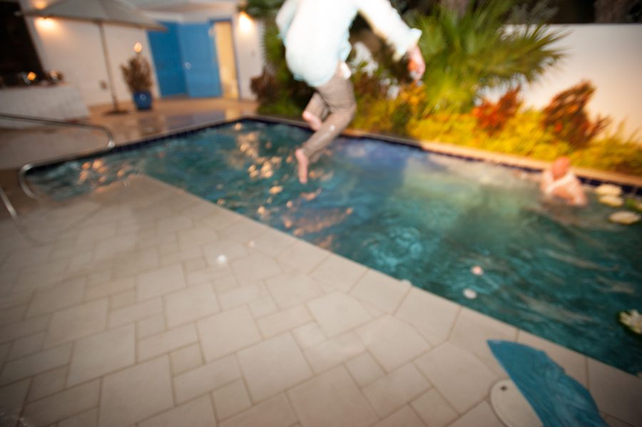 Someone jumps into the pool during Lauren and Justin's wedding at the CuisinArt Resort & Spa in Anguilla, BWI.