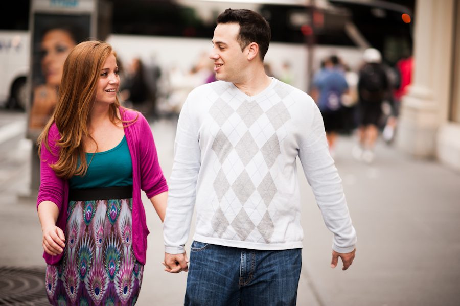 Lauren and Tony walk along 5th Avenue during their engagement session with awesome NYC wedding photographer Ben Lau.