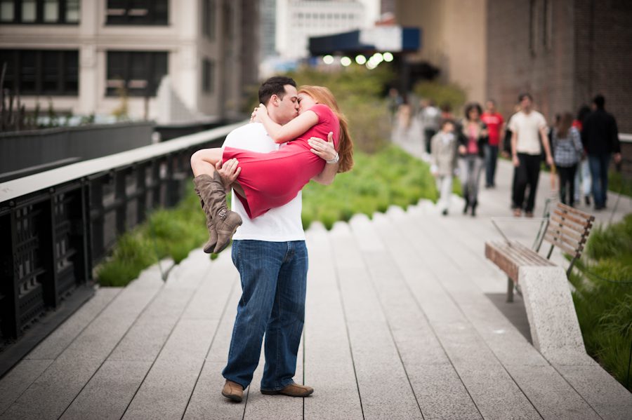 Tony picks Lauren up into the air during their engagement session with NYC wedding photographer Ben Lau.