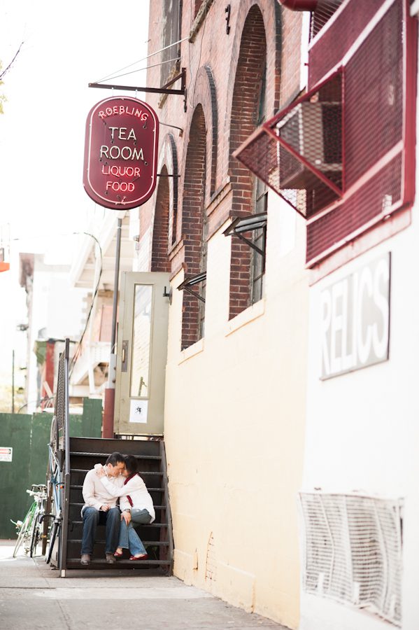 Lisa and Kai share a kiss outside Roebling Tea room during their engagement session in Williamsburg with awesome New York City wedding photographer Ben Lau.