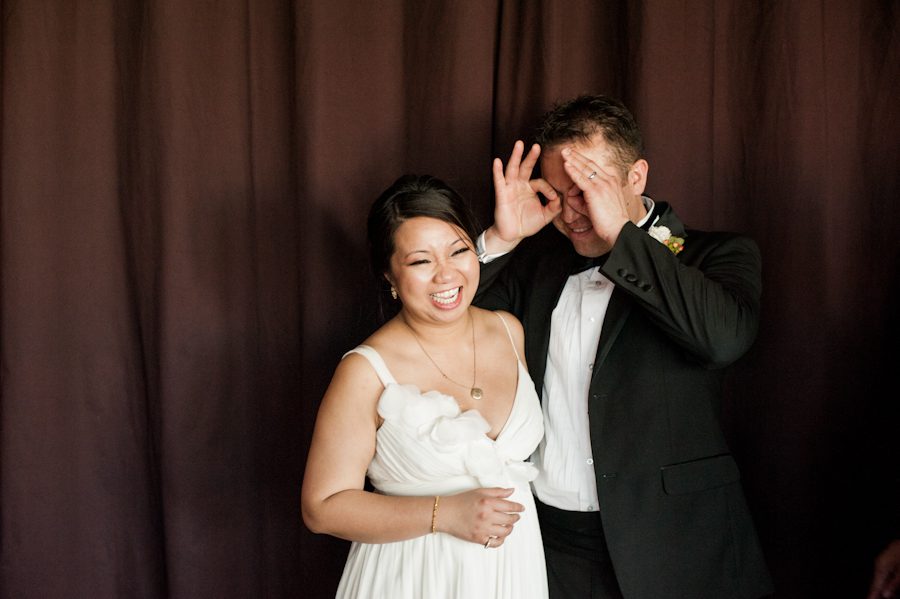 Groom makes binoculars during portraits at their wedding reception in Washington DC. Captured by Ben Lau Photography.