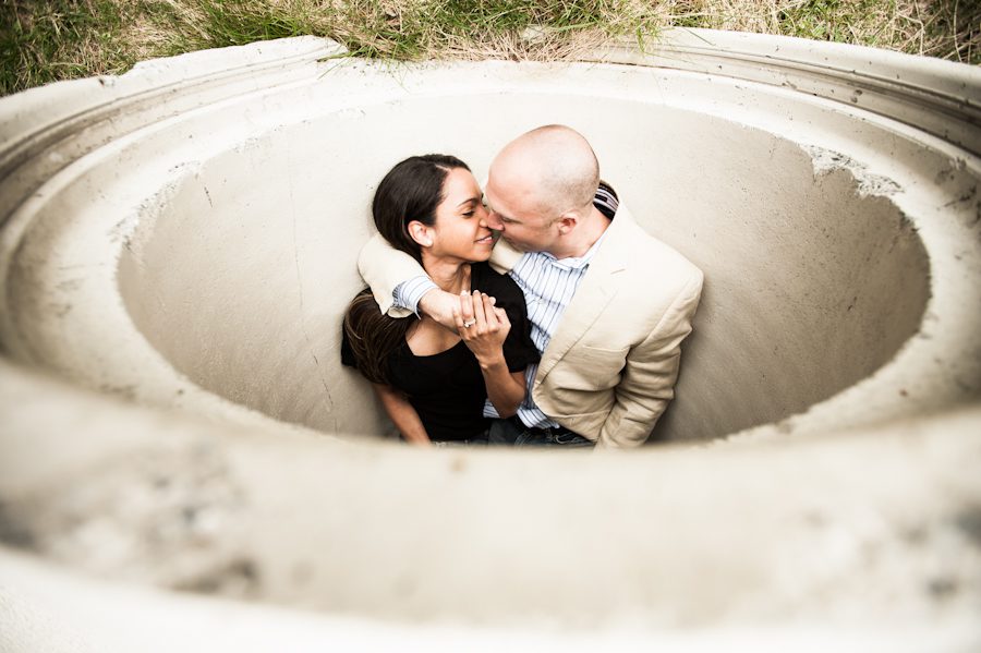 Patrice and Josh embrace inside a concrete tube in Jersey City, NJ during their engagement session with awesome Northern NJ Wedding Photographer Ben Lau.