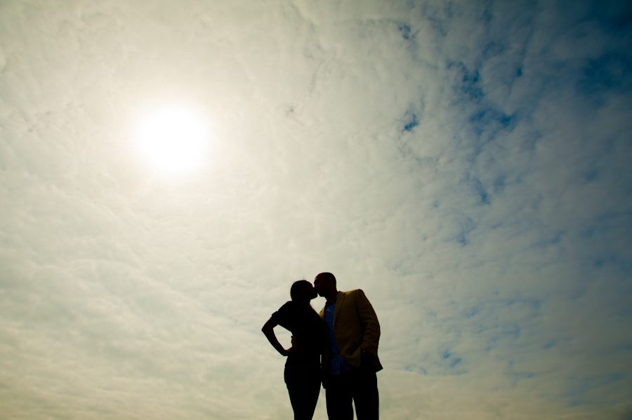 Patrice and Josh share a kiss in the open skies during their engagement session in Jersey City, NJ with awesome northern NJ wedding photographer Ben Lau.