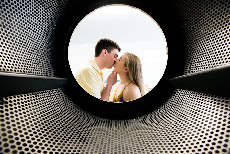 Alexis and Mike share a kiss inside a laundromat during their engagement session with awesome NJ wedding photographer Ben Lau on Long Beach Island.