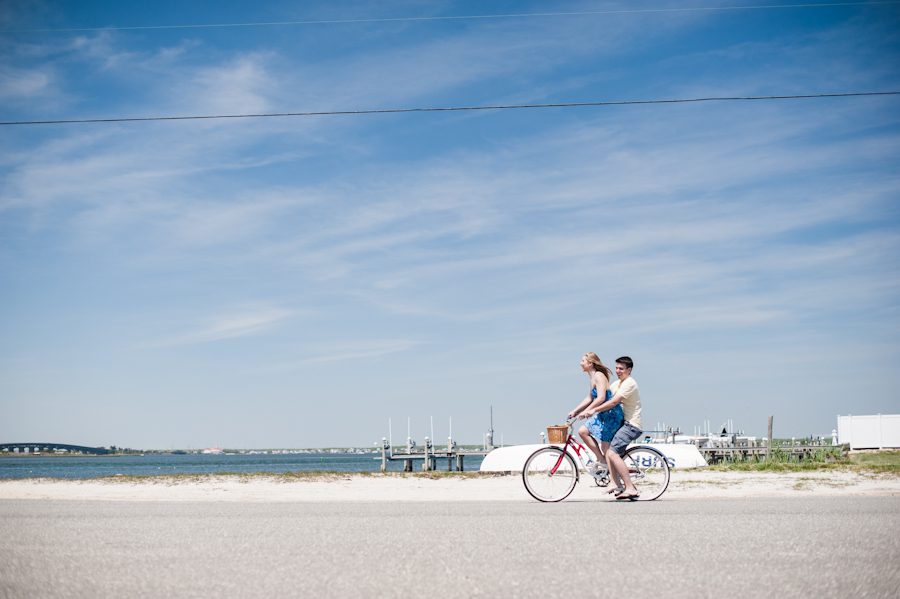 Alexis and Mike ride their bikes by the beach during their engagement session with awesome NJ wedding photographer Ben Lau.