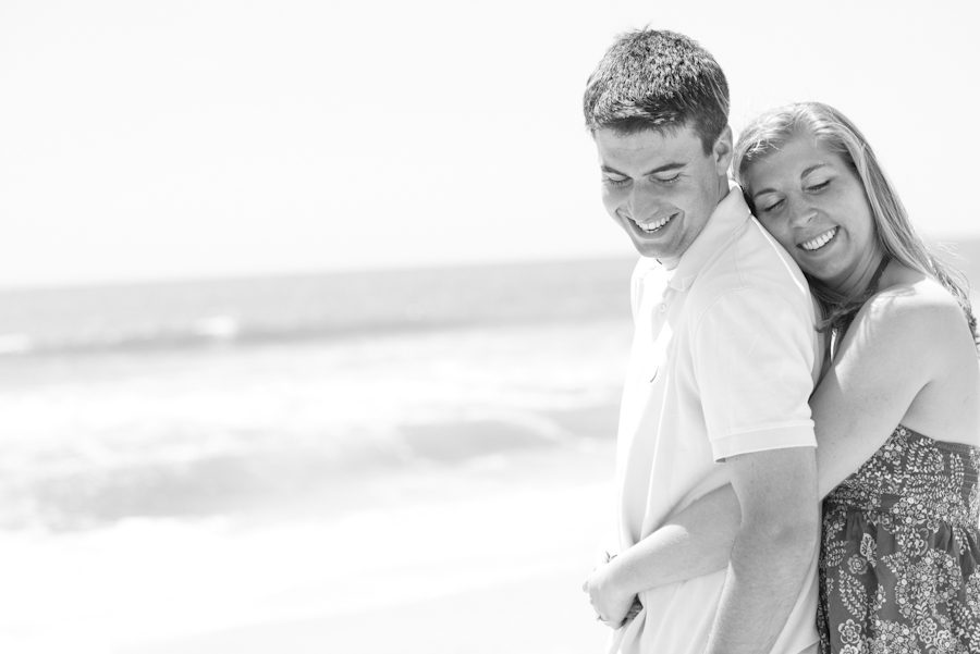 Alexis hugs Mike on the beach during their engagement session with awesome NJ wedding photographer Ben Lau on Long Beach Island.