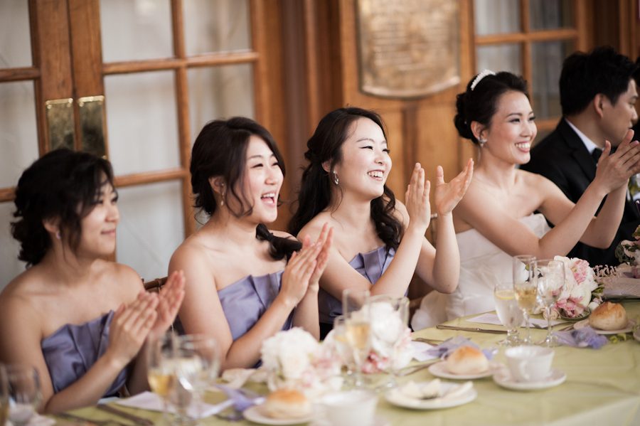 Bridal party cheers during speeches at Snug Harbor, Staten Island. Captured by New York City wedding photographer Ben Lau.