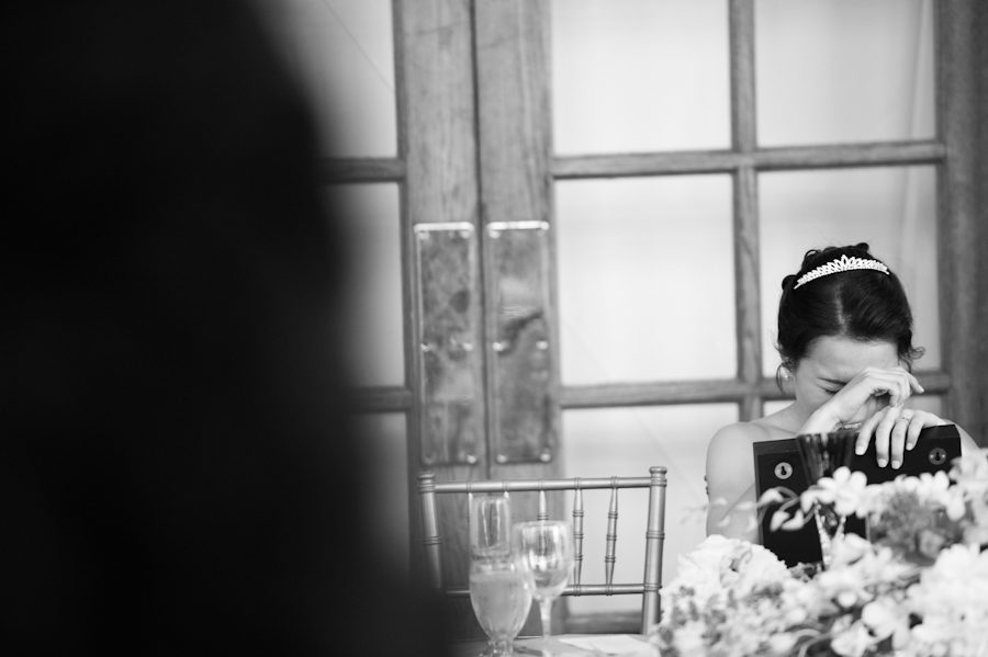 Bride reacts during the speeches at her wedding in Snug Harbor, Staten Island. Captured by New York City wedding photographer Ben Lau.