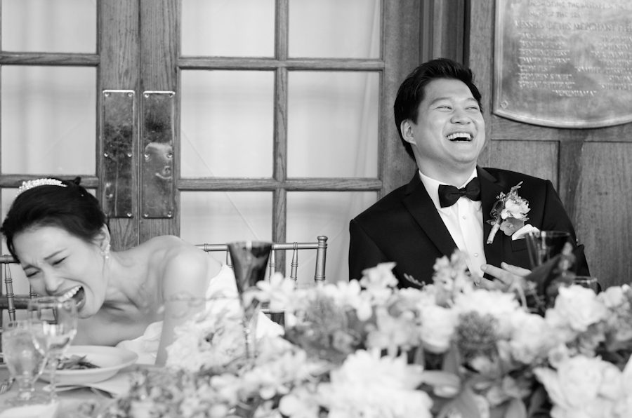 Bride nearly falls out of her seat during speeches at her wedding at Snug Harbor, Staten Island. Captured by awesome New York City wedding photographer Ben Lau.