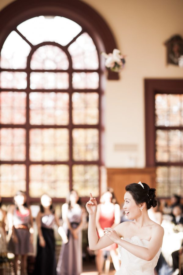 Bouquet toss during reception at Snug Harbor, Staten Island. Captured by New York City wedding photographer Ben Lau.