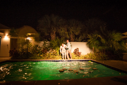 Groom jumps into pool during his reception at the CuisinArt Resort & Spa in Anguilla. Captured by Caribbean destination wedding photographer Ben Lau.