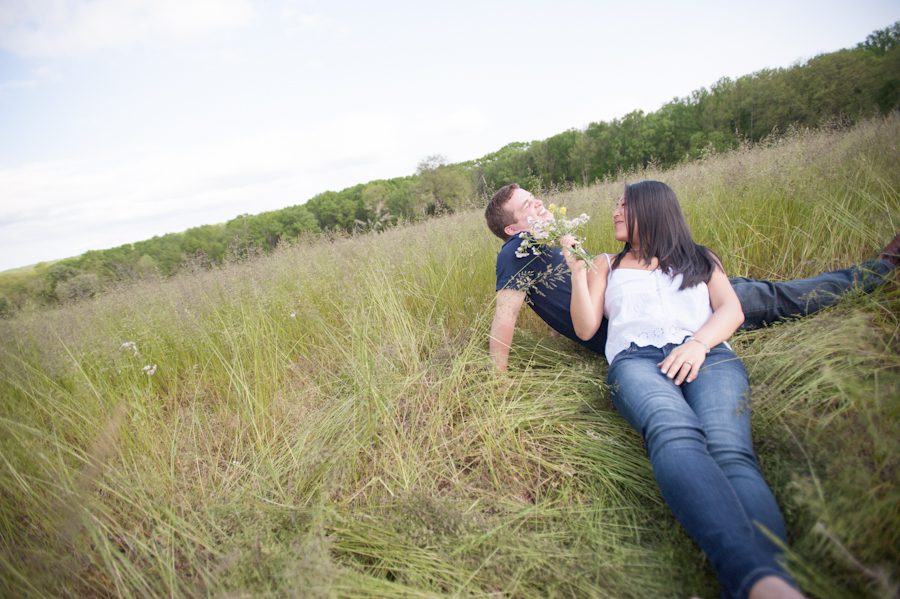 Kelly and Rob play in a field during their engagement session in NJ wine country with awesome Central NJ wedding photographer Ben Lau.