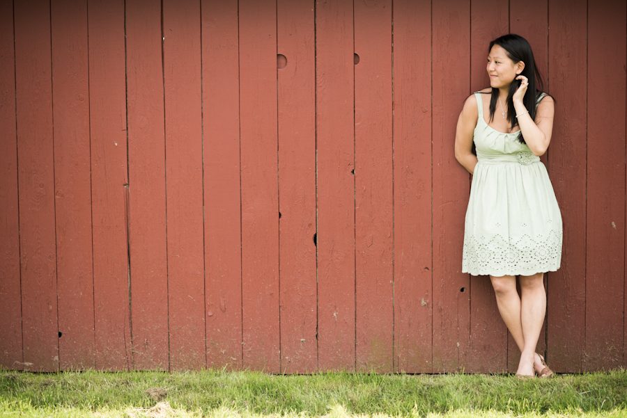 Kelly poses along a barn wall during her engagement session in NJ wine country with awesome central New Jersey wedding photographer Ben Lau.