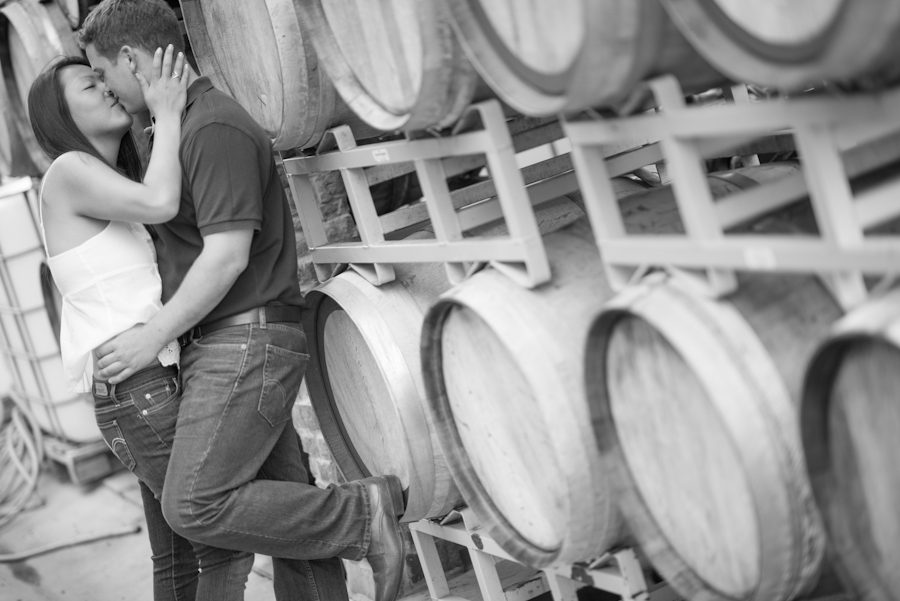 Kelly and Rob share a kiss in a NJ winery during their engagement session with awesome Central NJ wedding photographer Ben Lau.