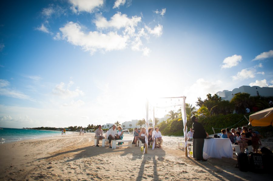 Sun sets over a wedding ceremony at the CuisinArt Resort & Spa in Anguilla. Captured by Caribbean destination wedding photographer Ben Lau.