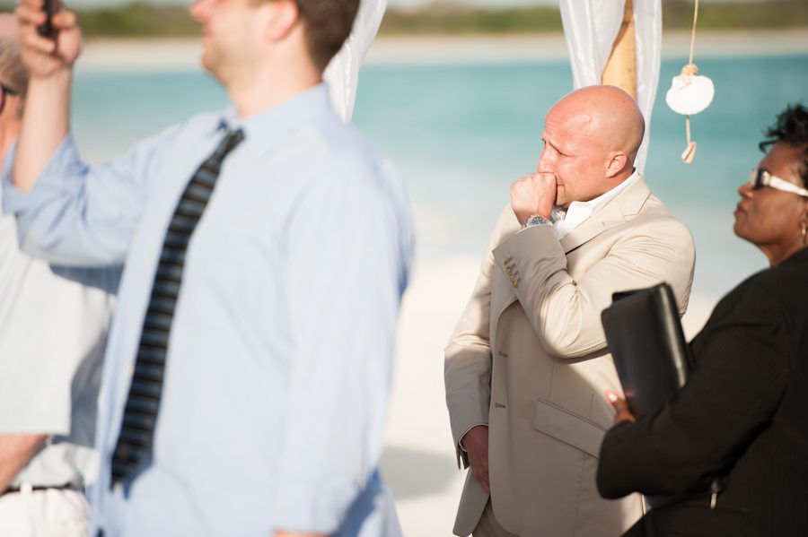 Groom cries during the procession at the CuisinArt Resort & Spa in Anguilla. Captured by Caribbean destination wedding photographer Ben Lau.