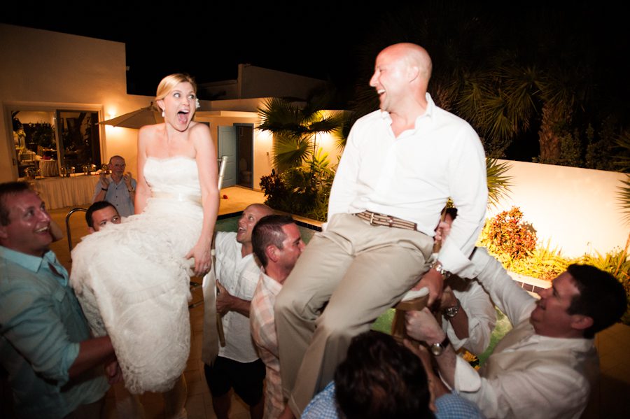 Chair dance for bride and groom during their reception at the CuisinArt Resort & Spa in Anguilla. Captured by Caribbean destination wedding photographer Ben Lau.