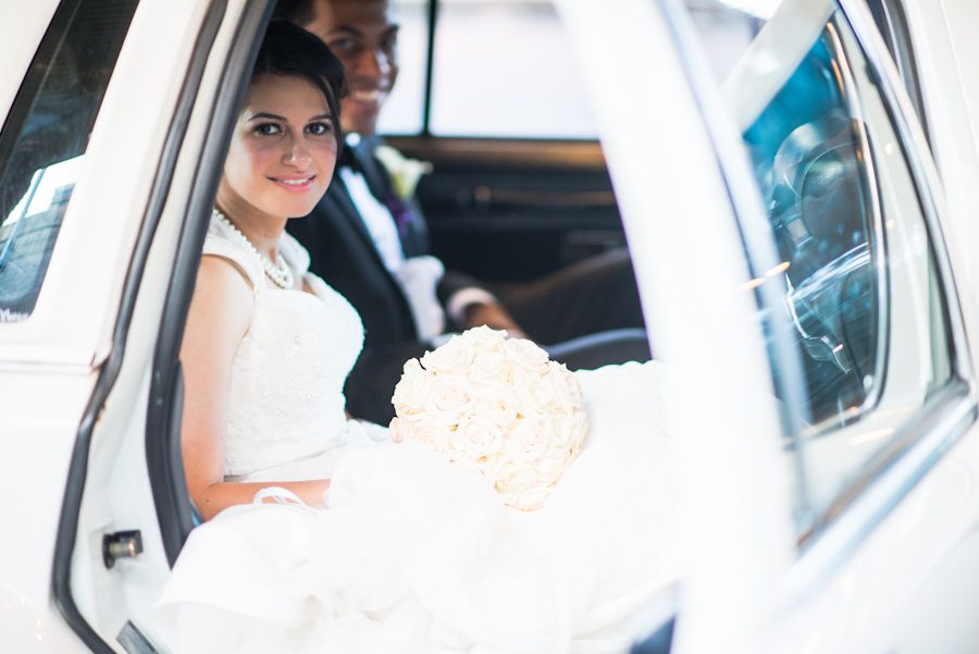Bride and groom in getaway car. Captured by awesome NJ wedding photographer Ben Lau.