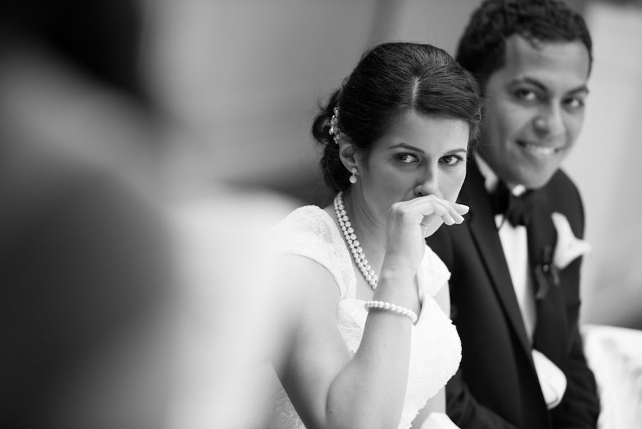 Bride reacts to Maid of Honor's speech during a wedding reception at the Palisadium in Cliffside Park, NJ. Captured by awesome NJ wedding photographer Ben Lau.