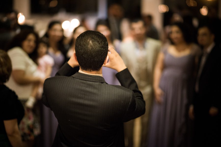 Guests taking photos during a wedding reception at the Palisadium in Cliffside Park, NJ. Captured by awesome NJ wedding photographer Ben Lau.