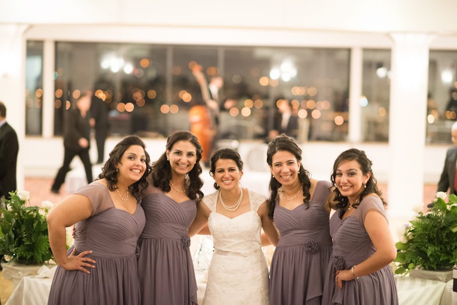 Bridesmaids get together during a wedding reception at the Palisadium in Cliffside Park, NJ. Captured by awesome NJ wedding photographer Ben Lau.