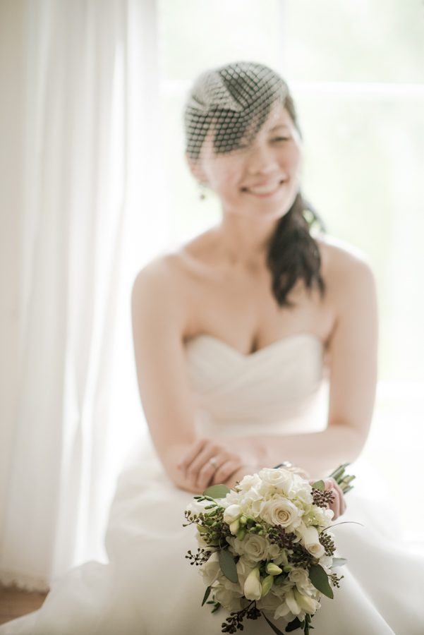 Bride sits with her bouquet at the Mountain Lakes House in Princeton, NJ. Captured by awesome NJ wedding photographer Ben Lau.