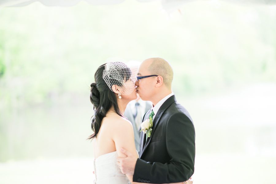Bride and groom share their first kiss at the Mountain Lakes House in Princeton, NJ. Captured by awesome NJ wedding photographer Ben Lau.