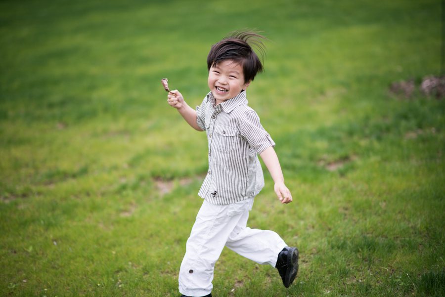 Boy running around at a wedding at the Mountain Lakes House in Princeton, NJ. Captured by awesome NJ wedding photographer Ben Lau.