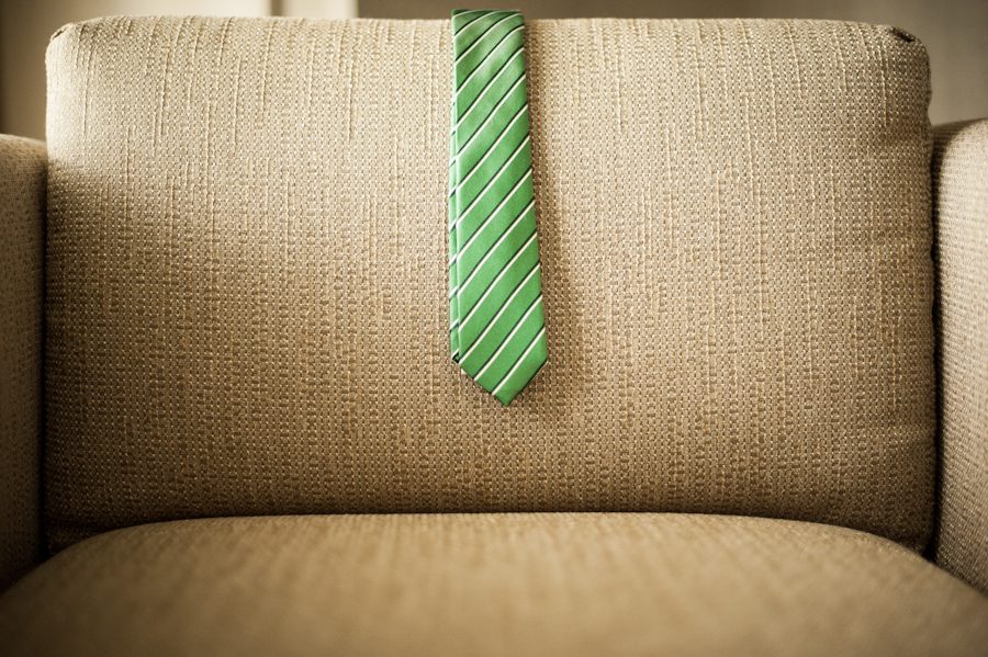 A green tie on a hotel couch. Captured by awesome NJ wedding photographer Ben Lau.