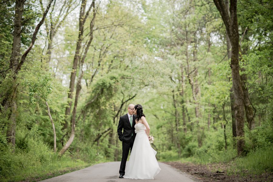 Bride and groom posing on a country road. Captured by awesome NJ wedding photographer Ben Lau.