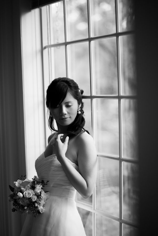 Bride poses by the window at the Mountain Lakes House in Princeton, NJ. Captured by awesome NJ wedding photographer Ben Lau.
