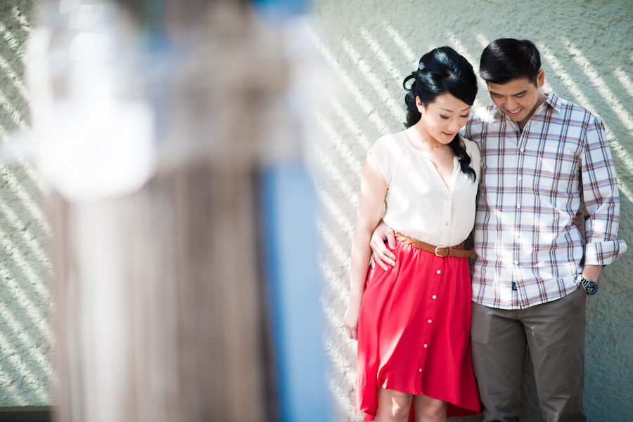 Yumi and Alan pose along a wall in Vinegar Hill during their engagement session with awesome NY wedding photographer Ben Lau.
