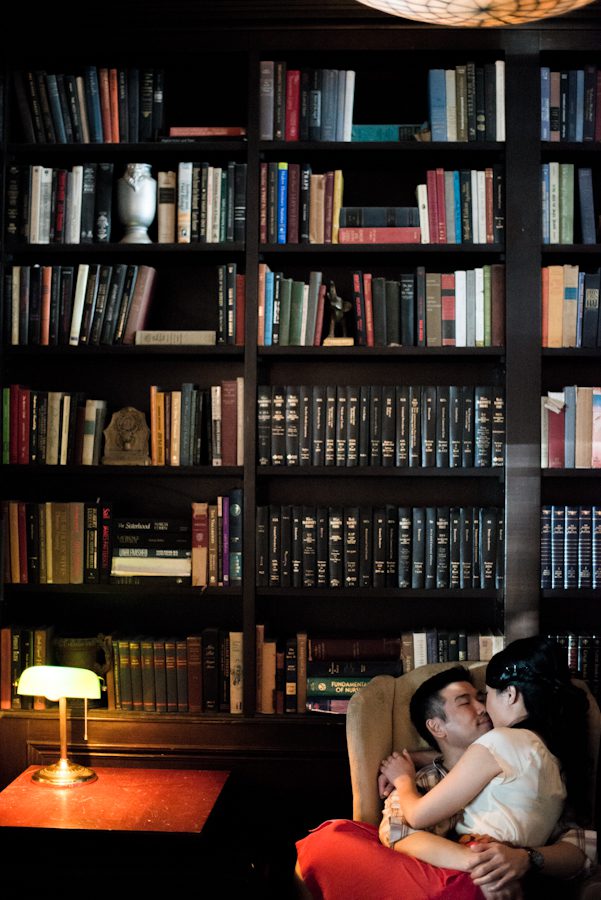 Yumi and Alan pose inside a library in Brooklyn NY during their engagement session.