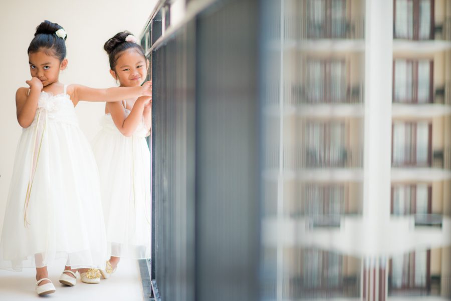 Flower girls play during bridal prep before a wedding at the Oxon Hill Manor in Oxon Hill, MD. Captured by awesome NJ wedding Photographer Ben Lau.