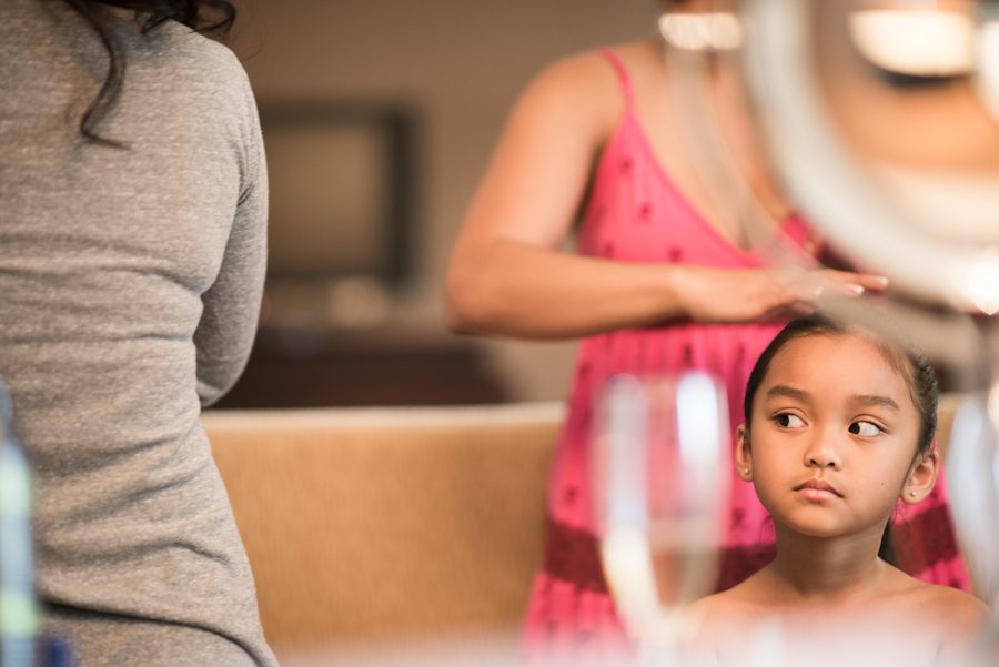 Flower girl gets her hair done during her prep at the Gaylord National Resort in Washington DC. Captured be awesome NJ wedding photographer Ben Lau.