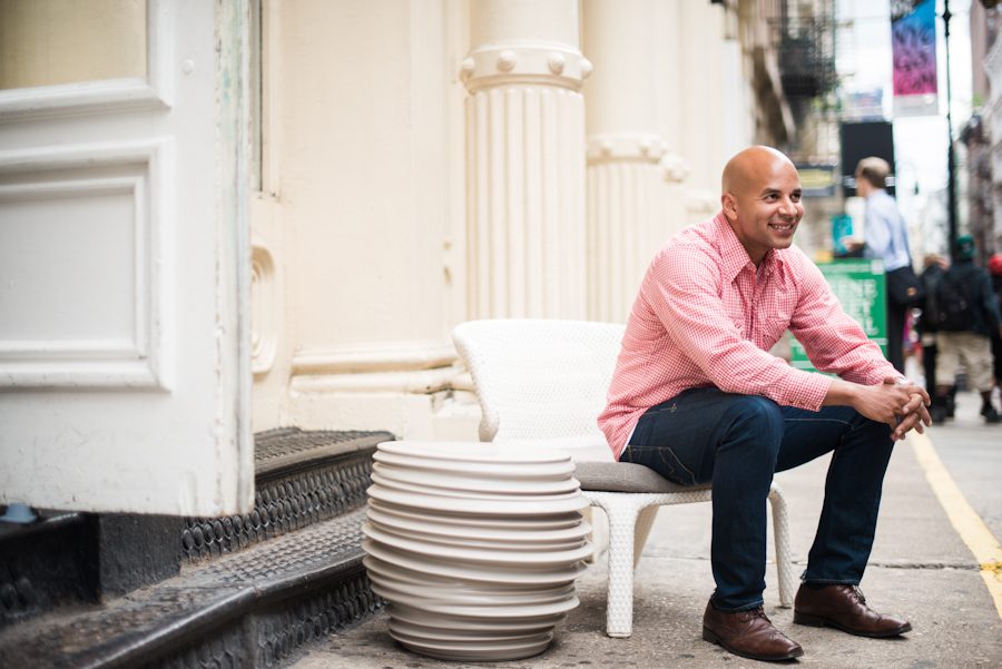 Jason sits on a chair in Soho during his engagement session with awesome NY wedding photographer Ben Lau.
