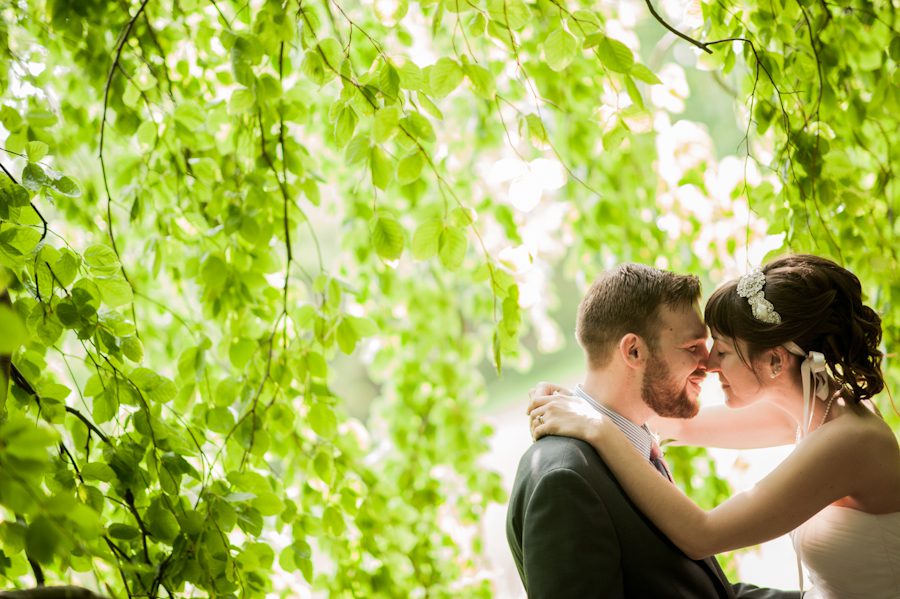 Bride and groom pose together on their wedding day at the Bayard Cutting Arboretum on Long Island, NY. Captured by awesome NJ wedding photographer Ben Lau.