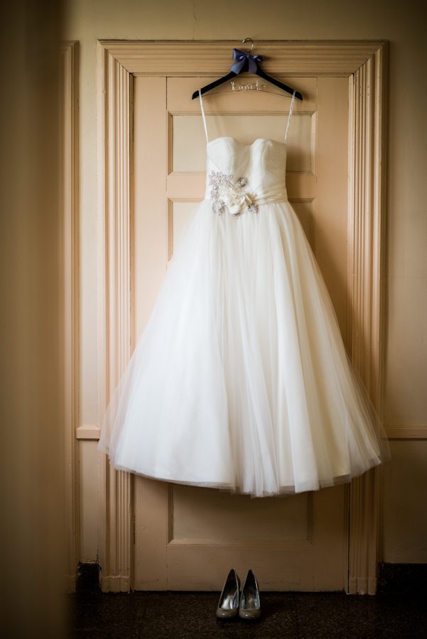 Bride's dress hangs on a door at the Bayard Cutting Arboretum in Long Island, NY. Captured by awesome NJ wedding photographer Ben Lau.