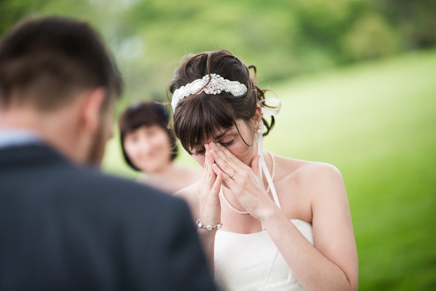 Bride cries during wedding ceremony at the Bayard Cutting Arboretum in Long Island, NY. Captured by awesome NJ wedding photographer Ben Lau.