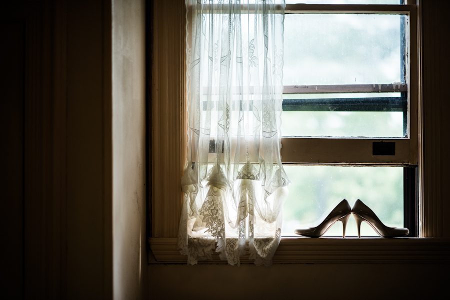 Shoes sit on the windowsill at the Bayard Cutting Arboretum in Long Island, NY. Captured by awesome NJ wedding photographer Ben Lau.