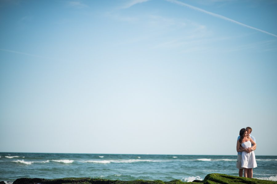 Nicole and Gregg pose on the surf in Long Beach Island, NJ during their engagement session with Ben Lau Photography.