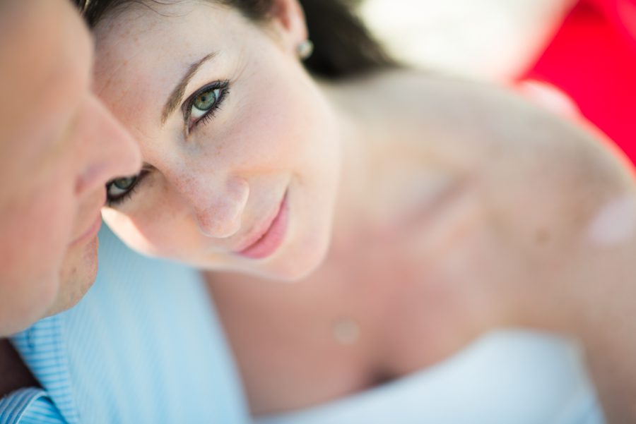Nicole looks up at the camera on Long Beach Island, NJ during their engagement session with Ben Lau Photography.