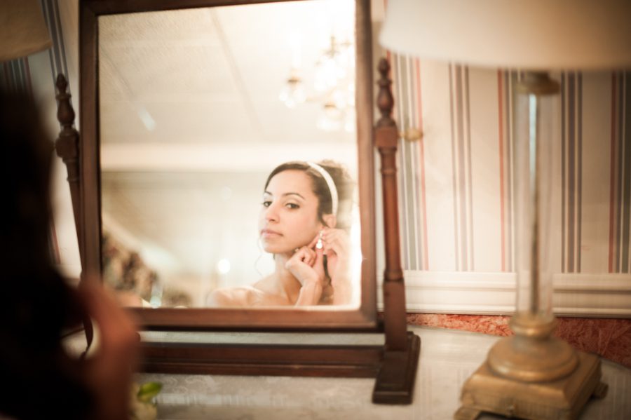 Bride puts on some final touches on her wedding day at The Manor in West Orange. Captured by best NJ wedding photographer Ben Lau.