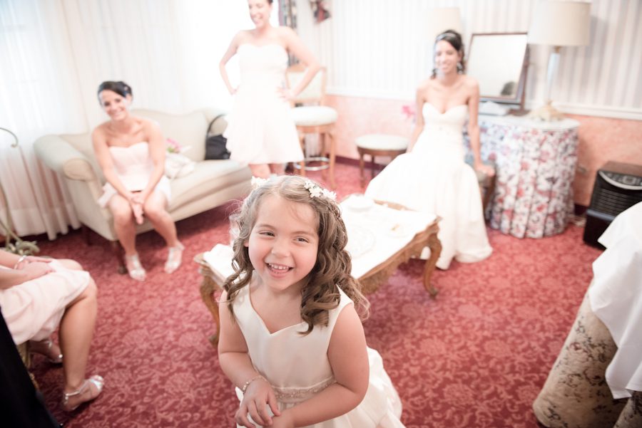 Flower girl poses for the camera on Patrice and Josh's wedding day at The Manor in West Orange. Captured by best NJ wedding photographer Ben Lau.