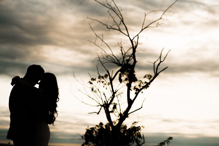 Sally and Terence kiss at sunset in Bear Mountain, NY. Captured by awesome NJ wedding photographer Ben Lau.