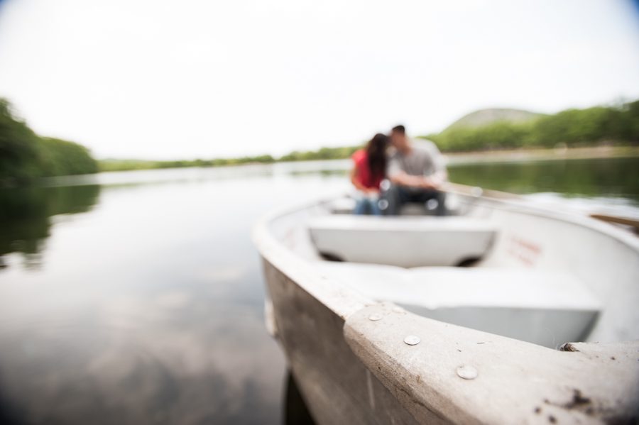 Sally and Terence sit in a boat on a lake in Bear Mountain, NY. Captured by awesome NJ wedding photographer Ben Lau.