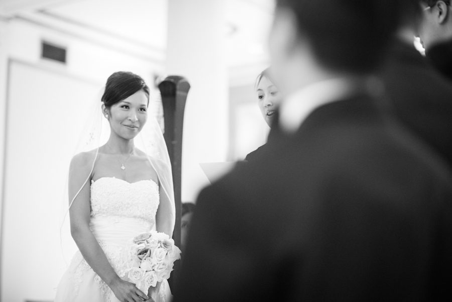 Bride smiles at groom on their wedding day in Montreal, QC. Captured by destination wedding photographer Ben Lau.