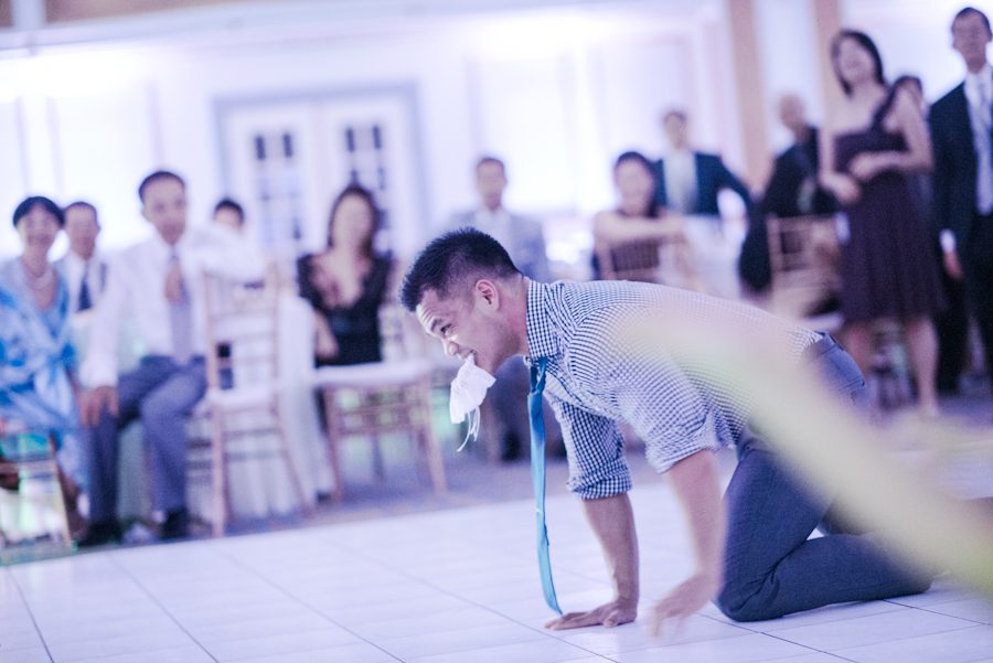 Garter toss on wedding day at Le Windsor in Montreal, QC. Captured by destination wedding photographer Ben Lau.